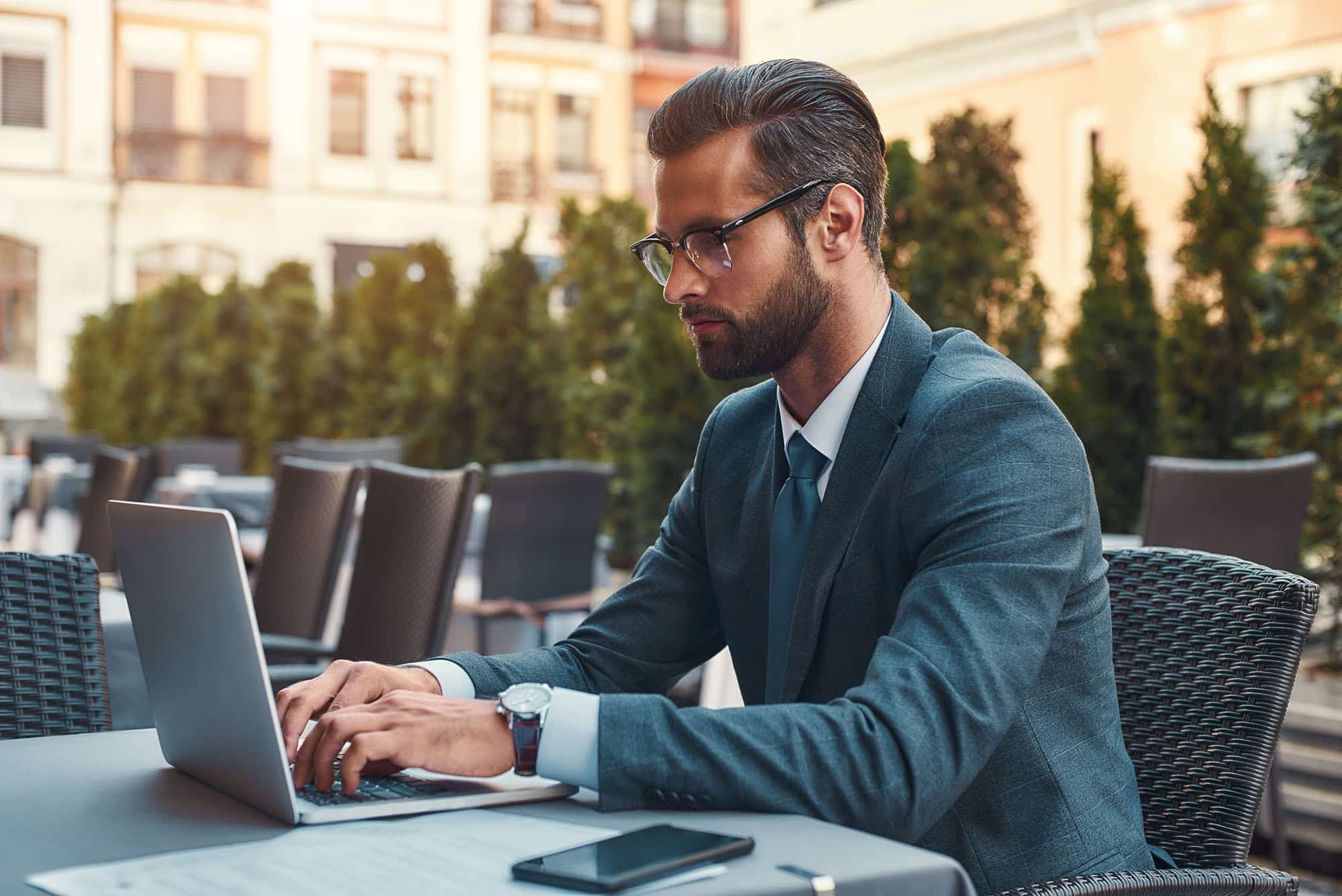 Business man at a restaurant working on his laptop